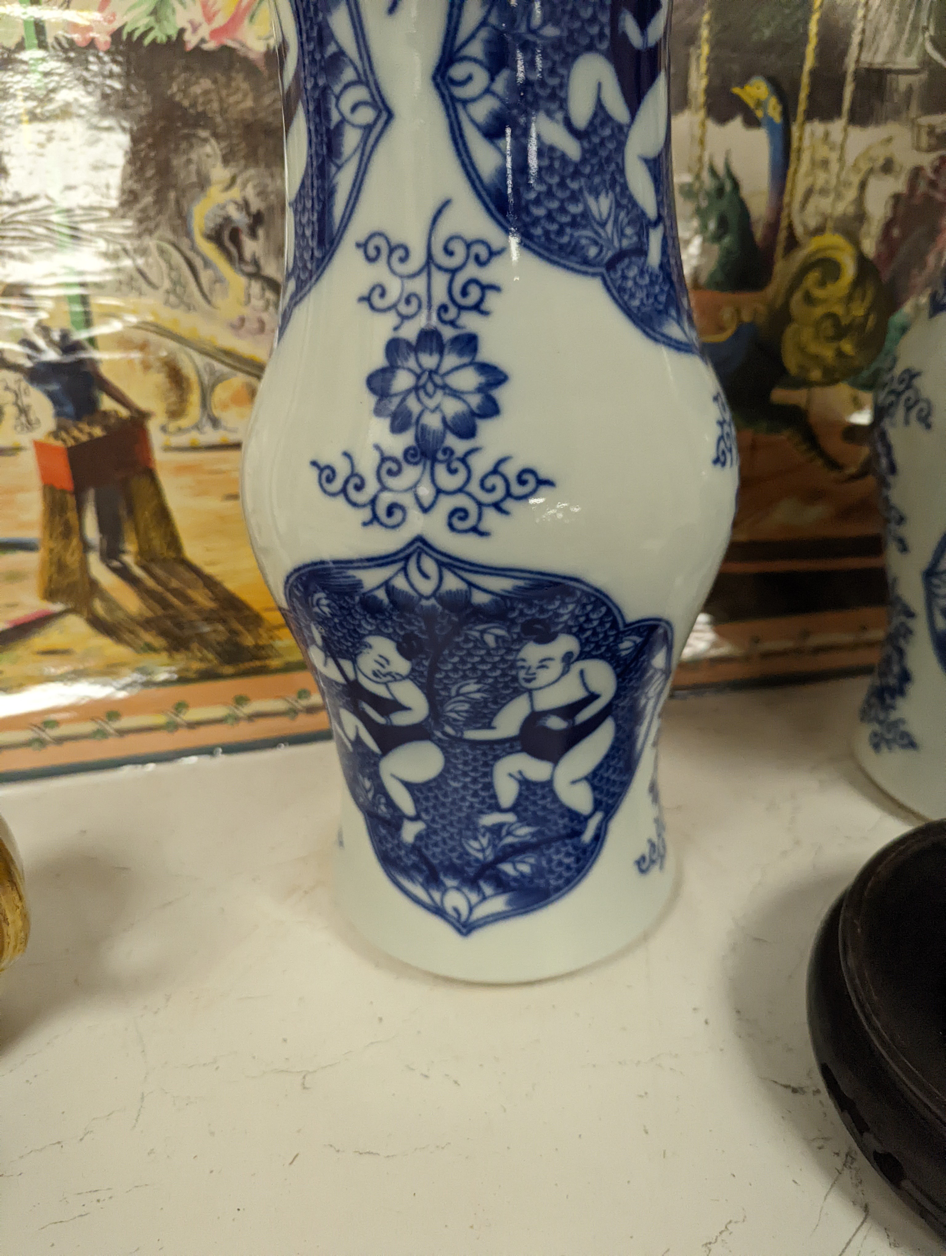 A pair of Chinese blue and white vases on stands and 6 further wood stands. Vases 35cm